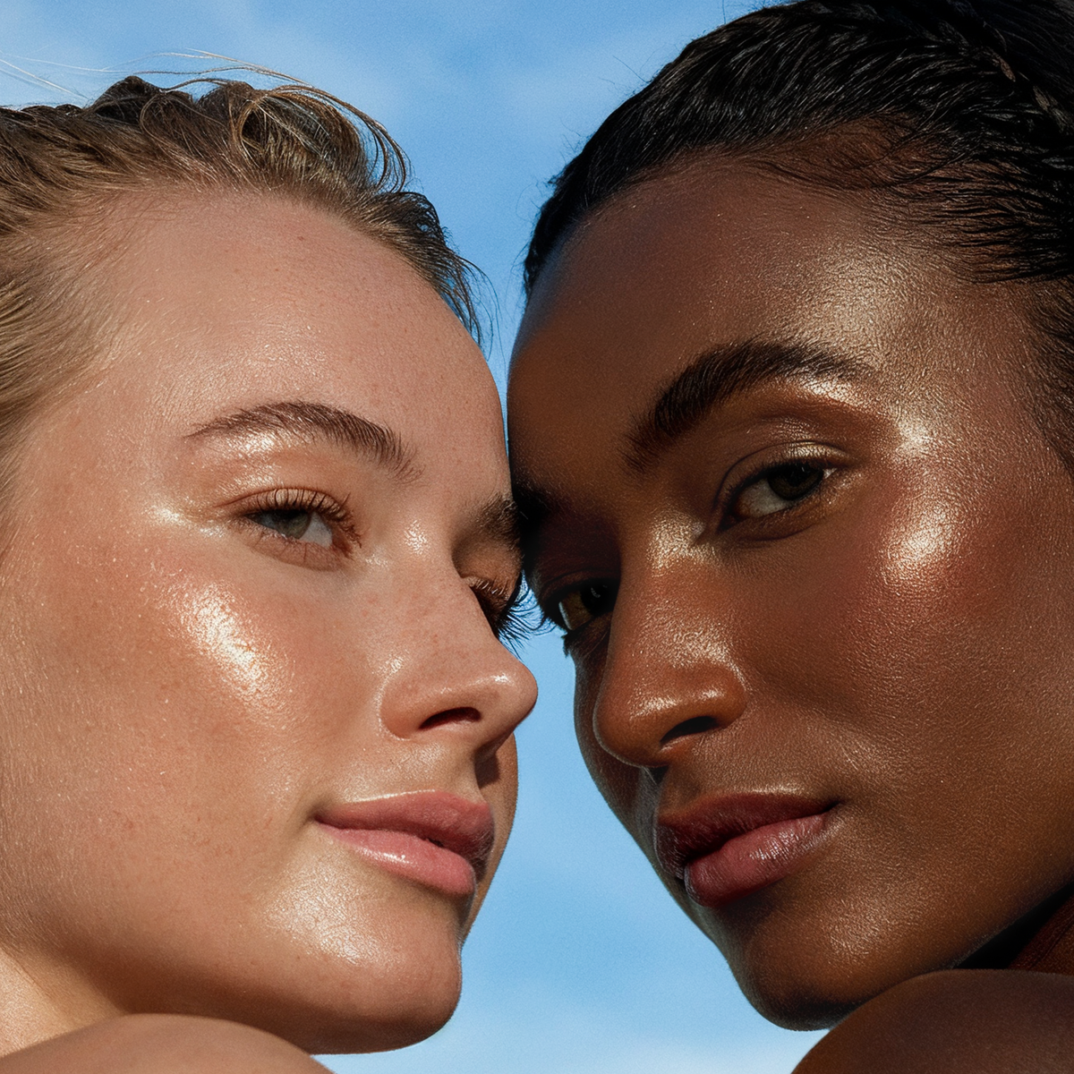 Close-up of diverse women showcasing radiant skin, representing natural sunscreen for women in a sunny setting