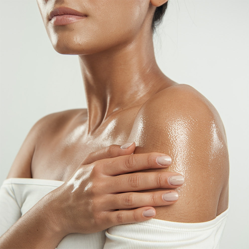 HERLOW body and post shave oil for women, enhancing skin glow and hydration on the shoulder
