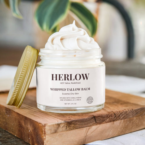 HERLOW whipped tallow balm in glass jar on wooden surface with creamy texture visible grass-fed tallow balm