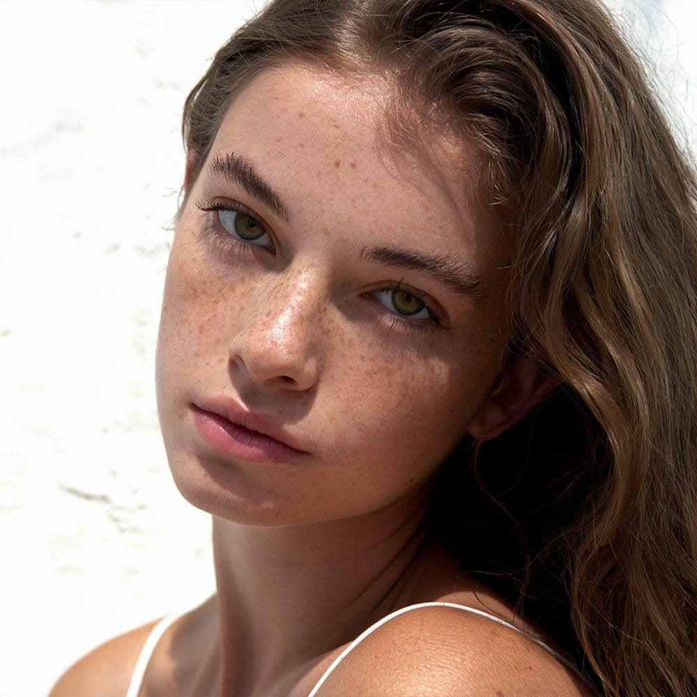 Close-up of a young woman with clear skin showcasing effects of HERLOW grass-fed tallow balm