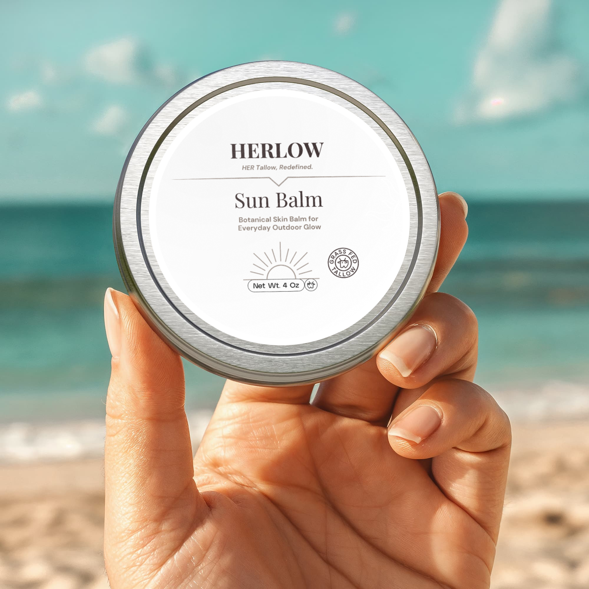 HERLOW Sun Balm in a hand at the beach, a hydrating sun balm for face for outdoor glow