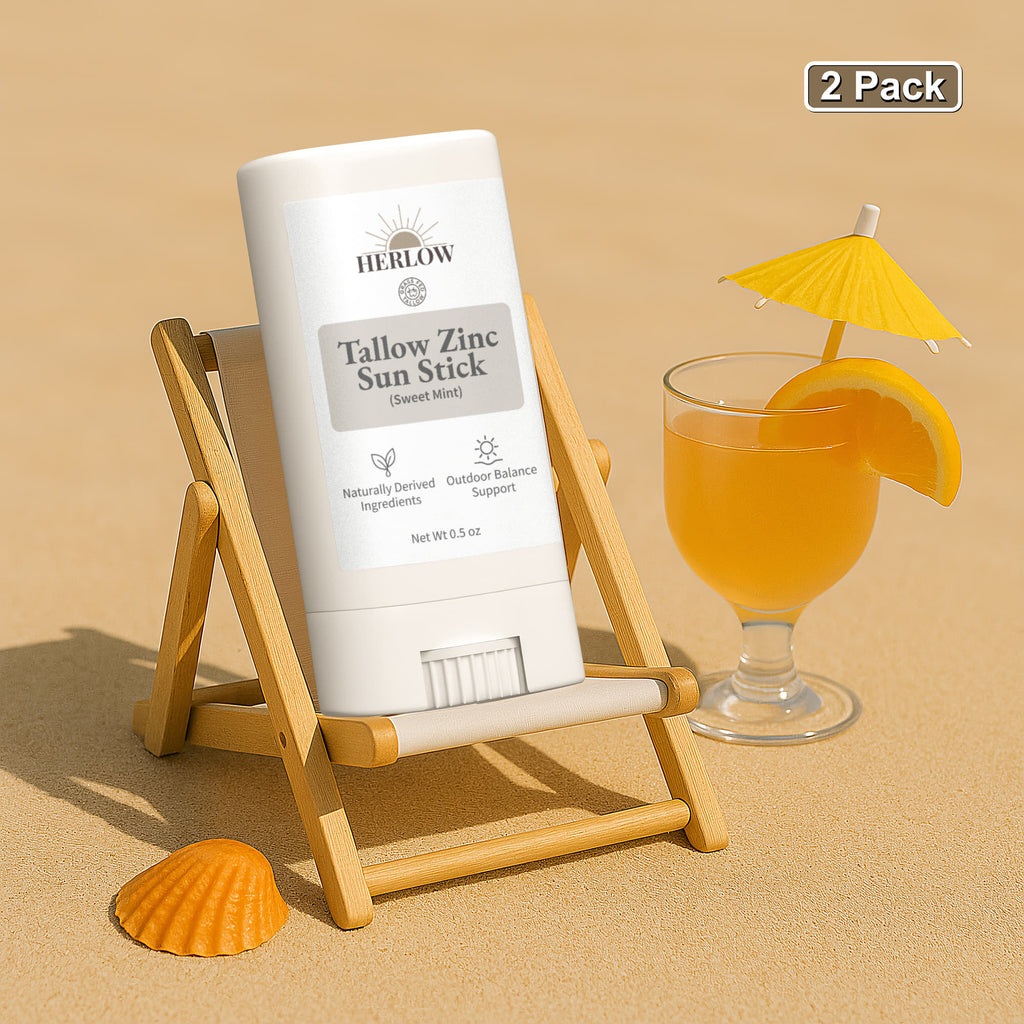 HERLOW Tallow Sun Stick in Sweet Mint on a beach with a drink and lounge chair